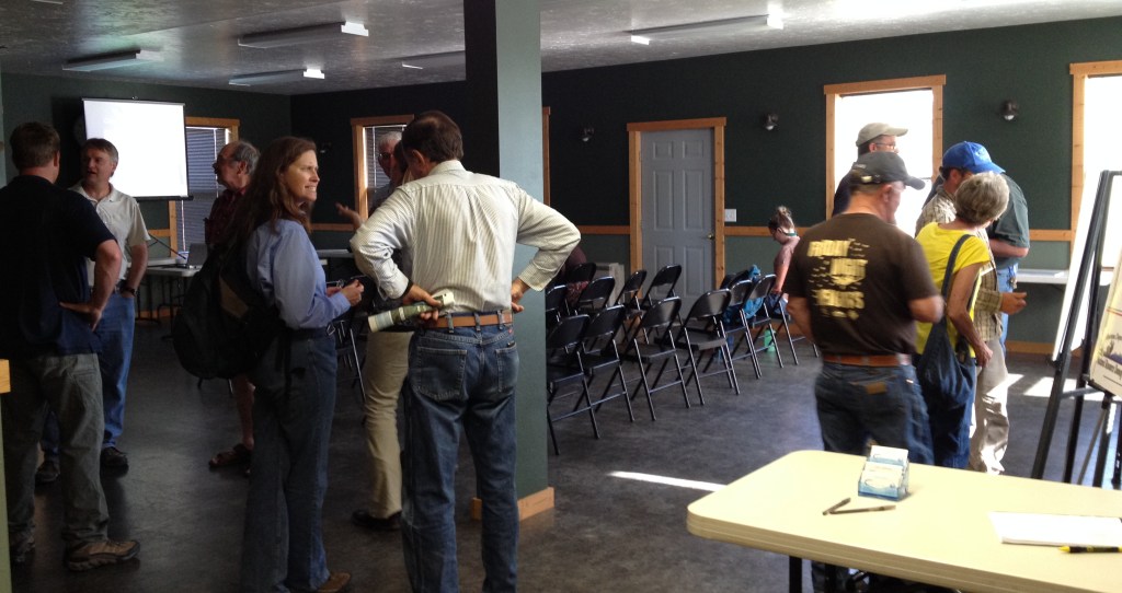 People standing around before a public meeting.