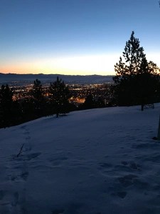 City of Helena, Montana in the early morning, lights shining. Picture taken from a mountain top in the snow as the author gets outdoor exercise.
