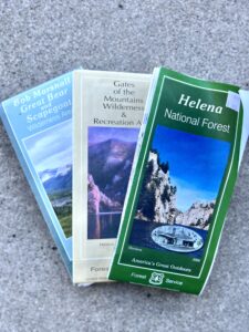 Three maps fanned out. Bob Marshall, Great Bear, and Scapegoat Wilderness, Gats of the Mountains Wilderness, and Helena National Forest.